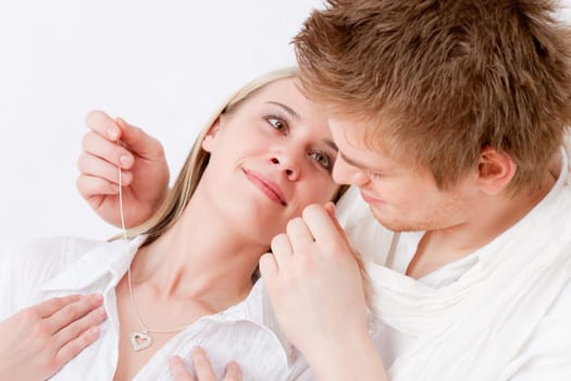 Couple in love - getting present necklace with heart pendant