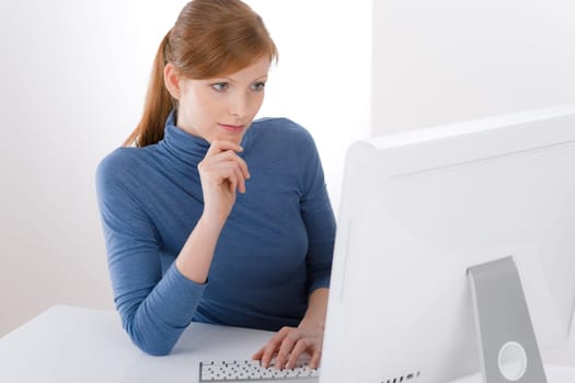 Modern office - young business woman work at computer