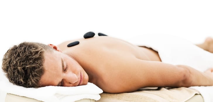 Young man enjoying the treatment in spa salon