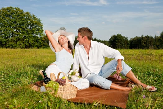 Picnic - Romantic couple in spring nature on sunny day