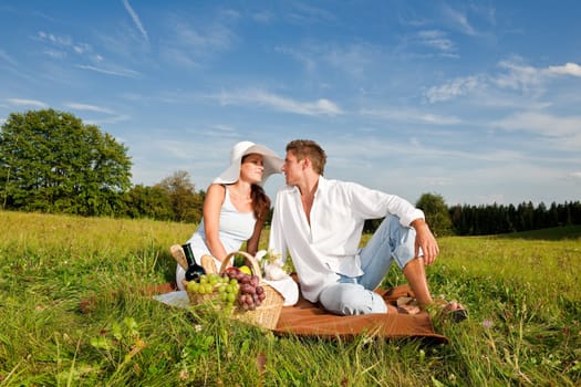 Picnic - Romantic couple in spring nature on sunny day