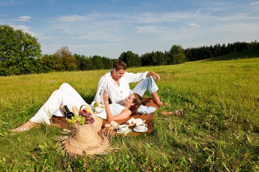 Picnic - Romantic couple in spring nature on sunny day