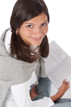 Portrait of teenager reading book on white background