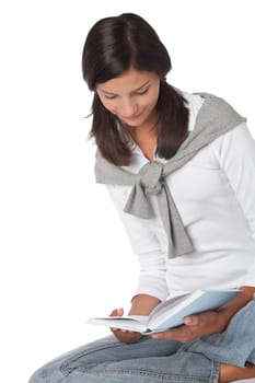 Teenager holding book and reading on white background
