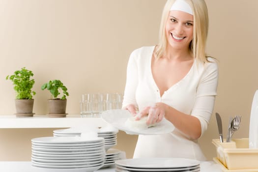 Modern kitchen - happy woman washing dishes, housework