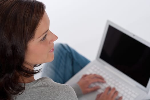 Beautiful happy woman with laptop on white background
