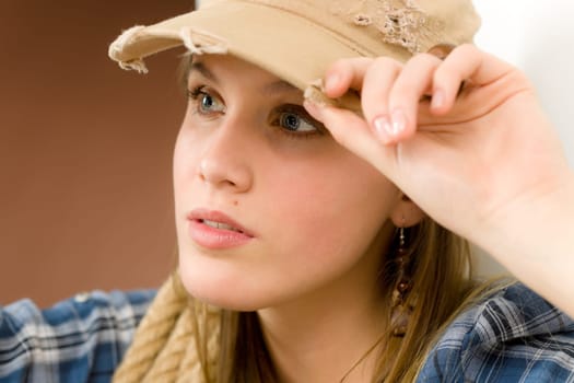 Fashion model - young woman country style posing with rope