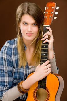 Rock musician - young fashion female model posing with guitar
