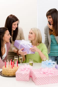 Birthday party - woman getting present with champagne and cake