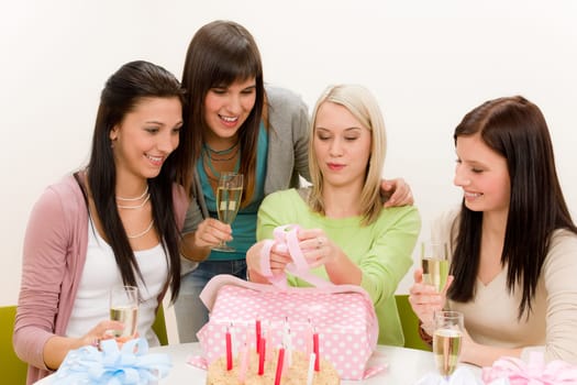 Birthday party - woman unwrap present, celebrating with champagne and cake