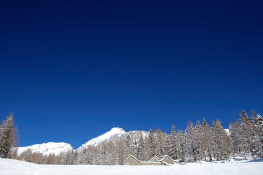 dramatic blue sky over snowy mountain top