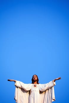 Jesus against clear blue sky, on old church.