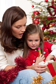 Mother with child opening present on Christmas