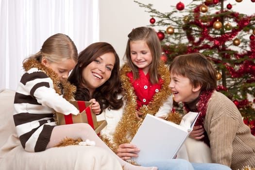 Happy family: mother with three children on Christmas