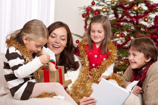 Happy family: mother with three children on Christmas