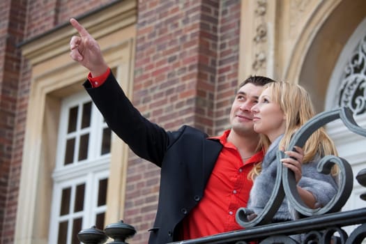 romantic couple outdoor - man pointing with a finger on something