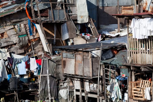 Shanty town - squatter homes. What appears to be a scene of utter disarray and randomness actually portrays several homes. Manila, Philippines. Photo taken using bubble-level.
