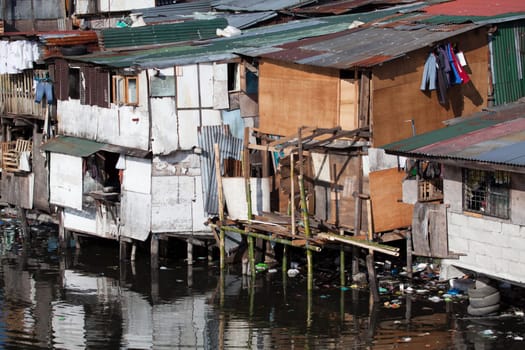 Squatter homes in the Philippines - shacks in shanty town along heavily polluted Paranaque river in Manila.
