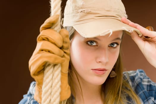 Fashion model - young woman country style posing with rope