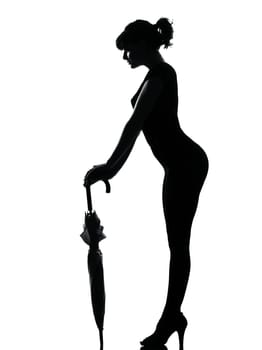 silhouette woman holding closed umbrella