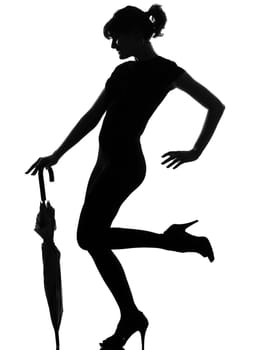 silhouette woman holding closed umbrella