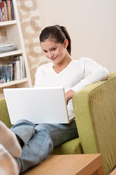 Students - Happy teenager with laptop in modern lounge sitting on armchair