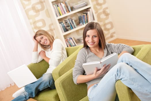 Students - Two female teenager studying with laptop and book in modern living room
