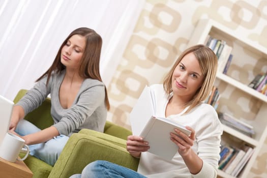 Students - Two female teenager studying sitting on green armchair