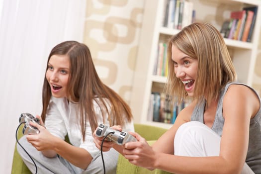 Students - Two happy female teenager playing TV game and having fun