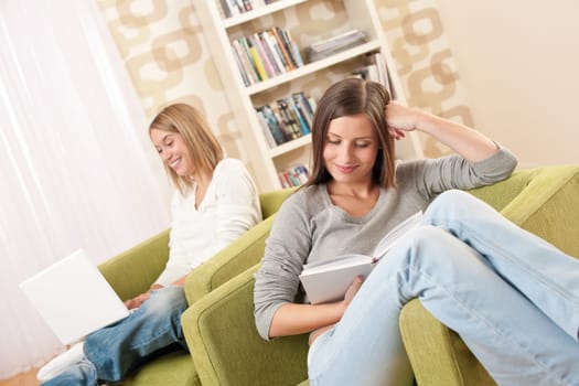 Students - Two female teenager studying with laptop and book in modern living room