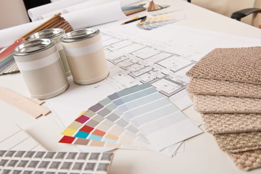 Office of interior designer with paint and color swatch on the desk
