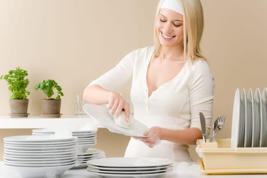 Modern kitchen - happy woman washing dishes, housework