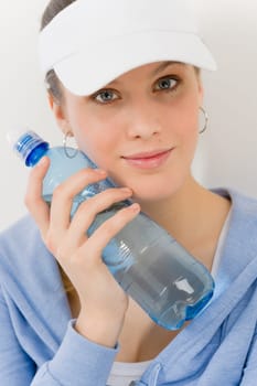 Sport - young woman in summer fitness outfit with water bottle