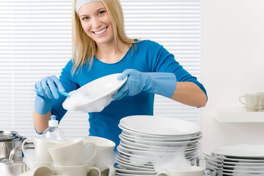 Modern kitchen - happy woman washing dishes, housework