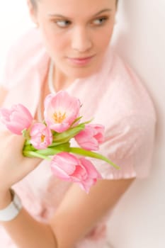 Fashion - young romantic woman in designer clothes with spring tulips