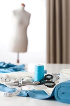 Fashion designer studio with professional equipment, sketches, mannequin, cloth