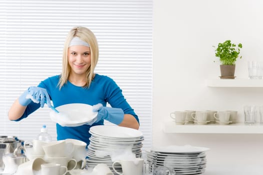 Modern kitchen - happy woman washing dishes, housework