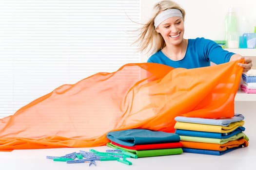 Laundry - woman folding clothes, housework