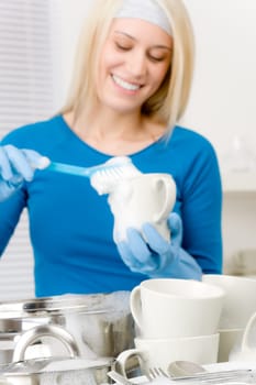 Modern kitchen - happy woman washing dishes, housework