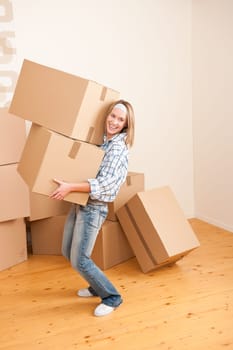 Moving house: Woman holding big carton box in new home