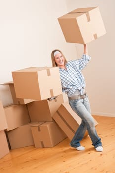 Moving house: Woman holding big carton box in new home