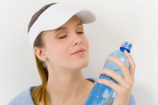 Sport - young woman in summer fitness outfit with water bottle