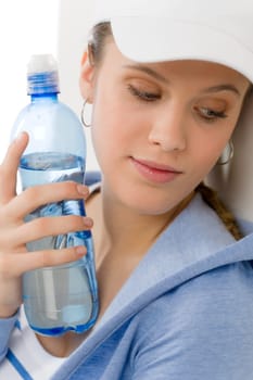 Sport - young woman in summer fitness outfit with water bottle