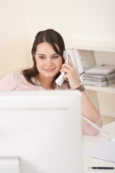 Portrait of attractive executive woman at office on phone