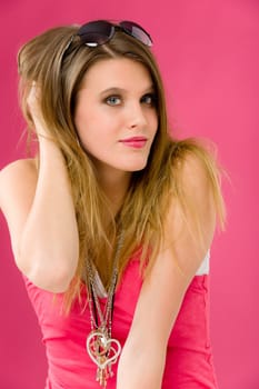 Fashion model - young trendy woman in pink, studio shoot