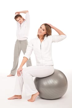 Fitness - Healthy couple stretching after training on white background