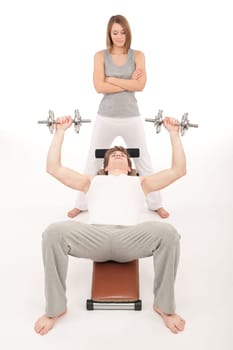 Fitness - young man exercising on bench on white background