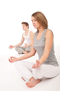 Fitness - Young healthy couple in yoga position on white background