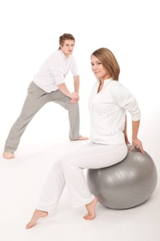 Fitness - Healthy couple stretching after training on white background