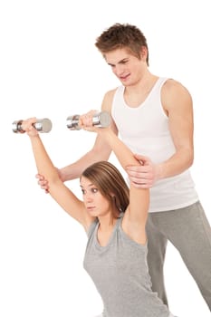 Fitness - Young woman with instructor lifting weights on white background